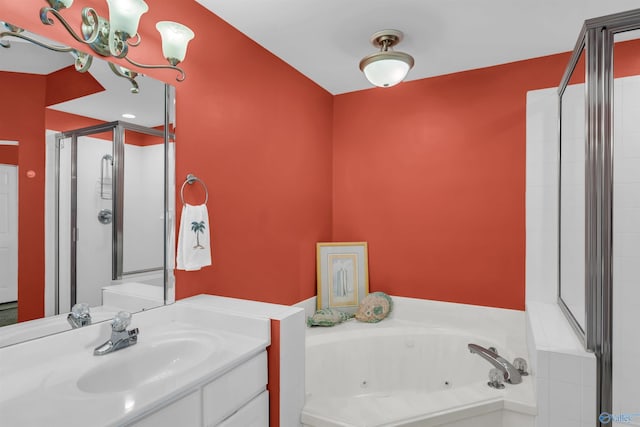 full bathroom featuring a stall shower, vanity, and a whirlpool tub