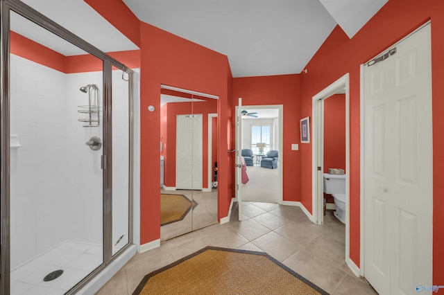 full bathroom with toilet, a shower stall, baseboards, and tile patterned flooring