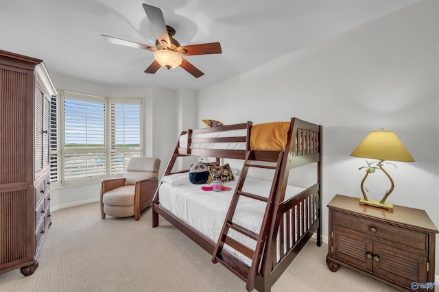 bedroom featuring baseboards, ceiling fan, and light colored carpet