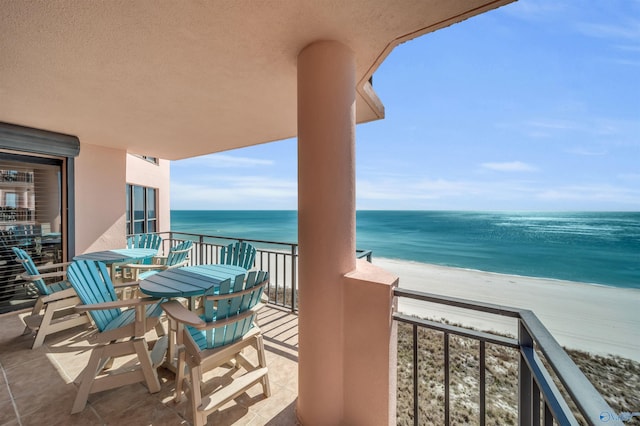 balcony featuring a water view and a view of the beach