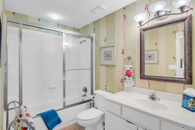 bathroom featuring bath / shower combo with glass door, visible vents, toilet, a textured ceiling, and vanity