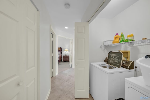 laundry room featuring laundry area, light tile patterned floors, and washer and dryer