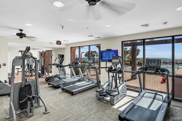 workout area with a ceiling fan, visible vents, and carpet floors