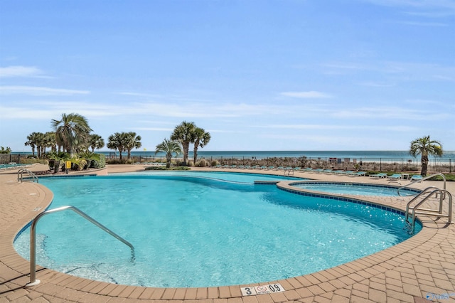 pool featuring a community hot tub and a patio area