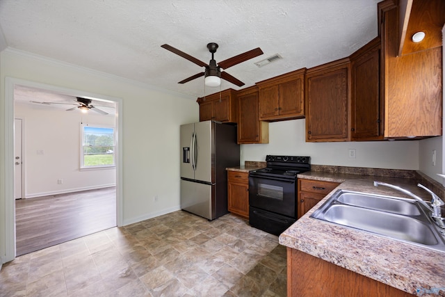 kitchen with a ceiling fan, a sink, stainless steel refrigerator with ice dispenser, and electric range
