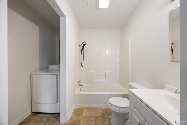 full bathroom featuring vanity, washer / dryer, toilet, baseboards, and a textured ceiling