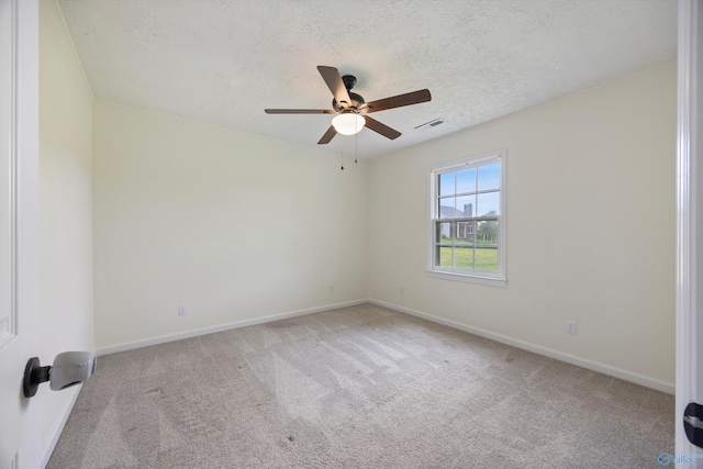 unfurnished room with carpet, ceiling fan, visible vents, and baseboards
