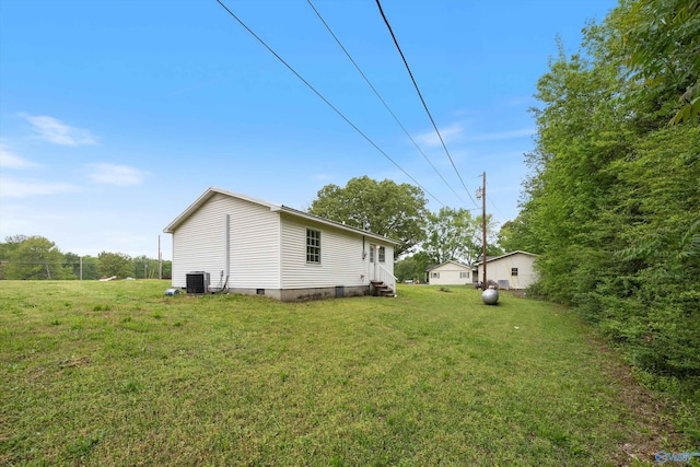 exterior space featuring a lawn, cooling unit, entry steps, and crawl space