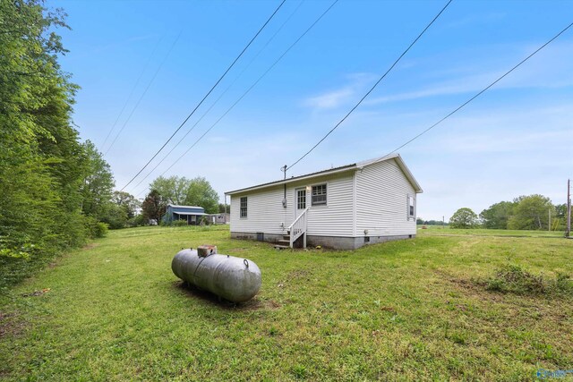 back of property featuring a lawn, crawl space, and entry steps