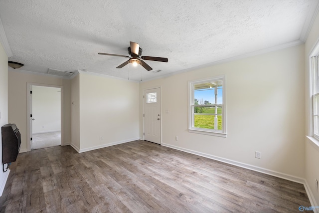 interior space featuring wood finished floors, a ceiling fan, a textured ceiling, and crown molding