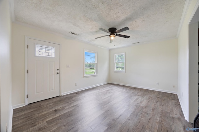 entrance foyer with crown molding, a ceiling fan, visible vents, and dark wood-style flooring