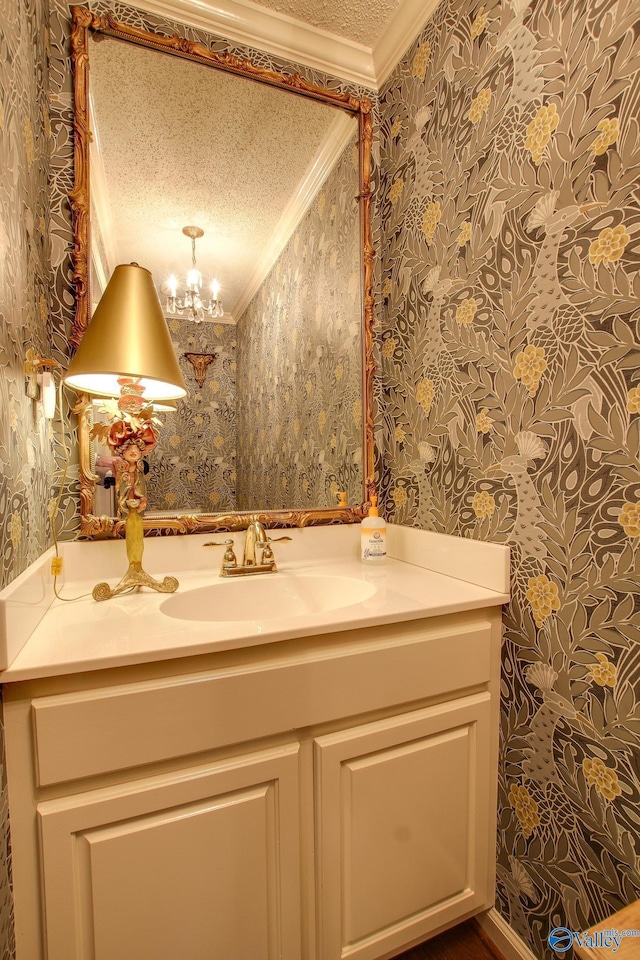 1625 River Bend Pl SE, Decatur, AL 35601 - bathroom with wallpapered walls, crown molding, vanity, a textured ceiling, and a chandelier