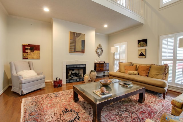 1625 River Bend Pl SE, Decatur, AL 35601 - living area featuring ornamental molding, wood finished floors, a tile fireplace, recessed lighting, and baseboards