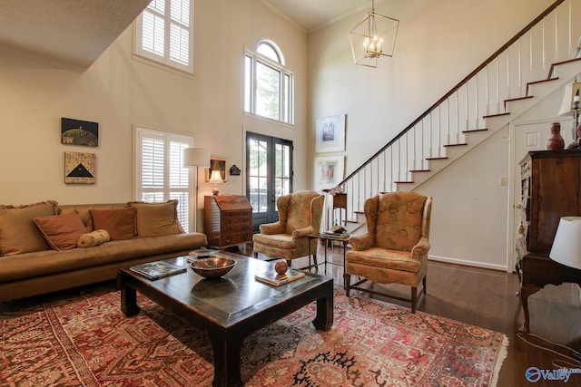 1625 River Bend Pl SE, Decatur, AL 35601 - living area with plenty of natural light, a towering ceiling, wood finished floors, a chandelier, and stairway