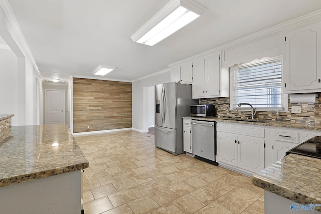 kitchen featuring tasteful backsplash, light stone counters, white cabinets, and appliances with stainless steel finishes