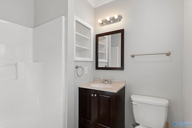 bathroom with vanity, toilet, and crown molding