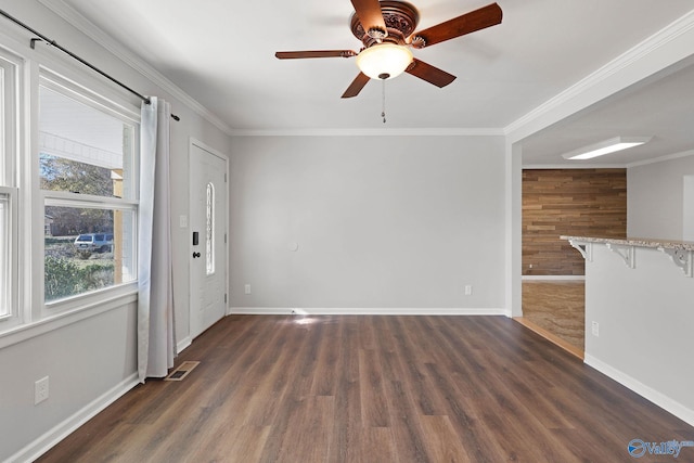 unfurnished living room with dark hardwood / wood-style flooring, ceiling fan, and ornamental molding