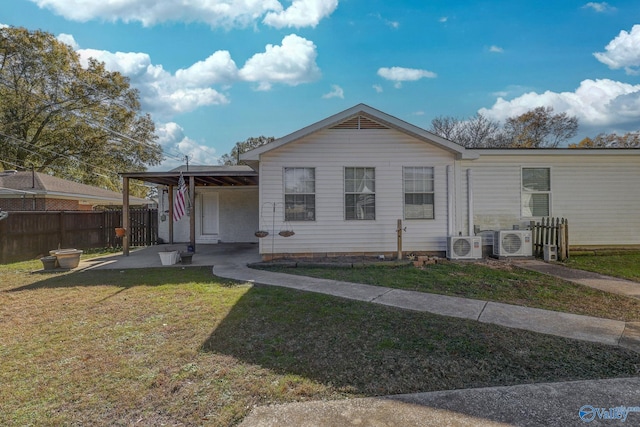 view of front of home with ac unit and a front yard