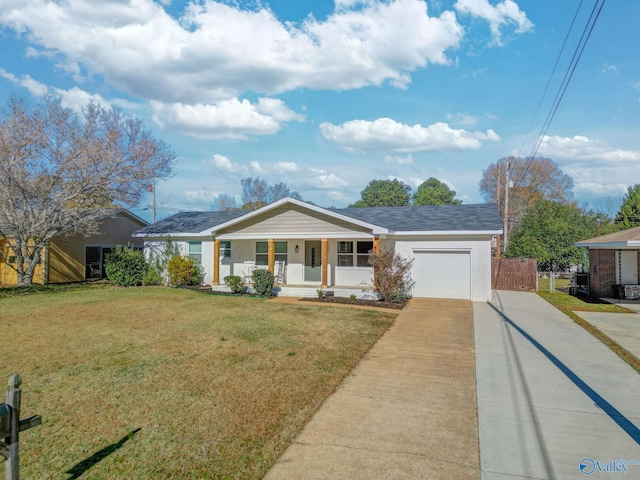 ranch-style home featuring a porch, a garage, and a front lawn