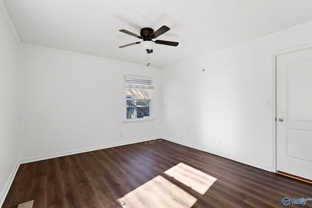 empty room with crown molding, ceiling fan, and dark wood-type flooring