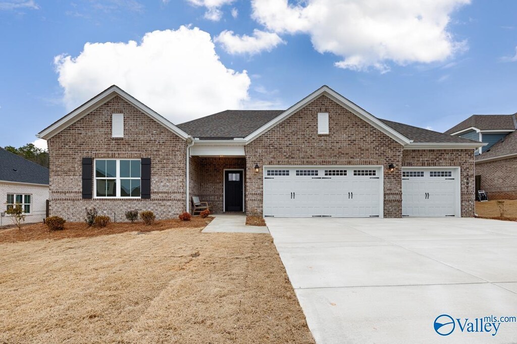 view of front of home featuring a garage and a yard