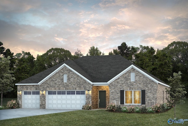 view of front of home featuring a garage and a yard