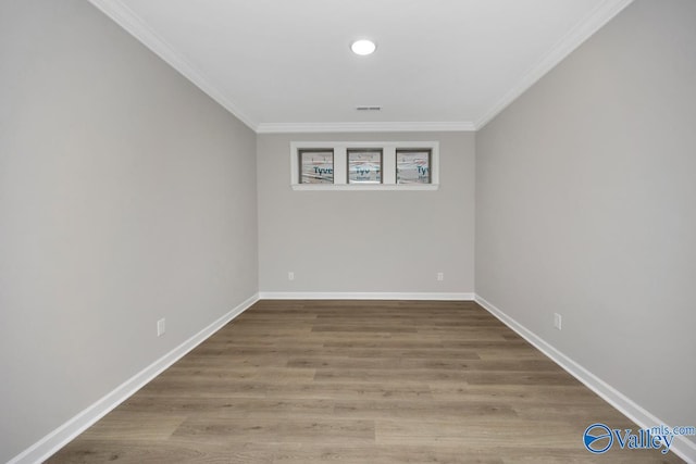 unfurnished room featuring crown molding and hardwood / wood-style flooring