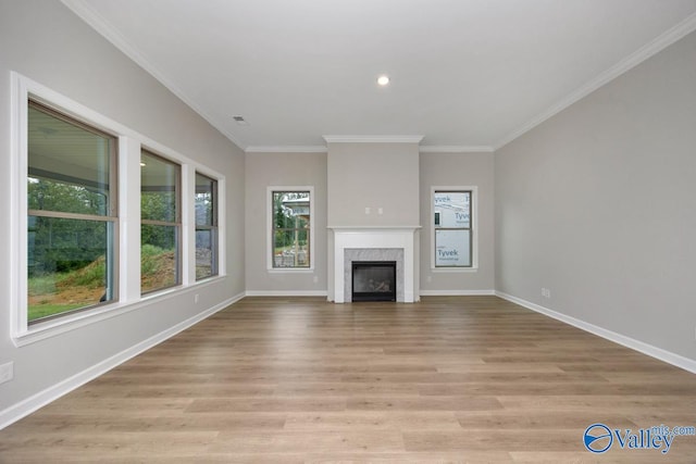 unfurnished living room featuring crown molding and light hardwood / wood-style flooring