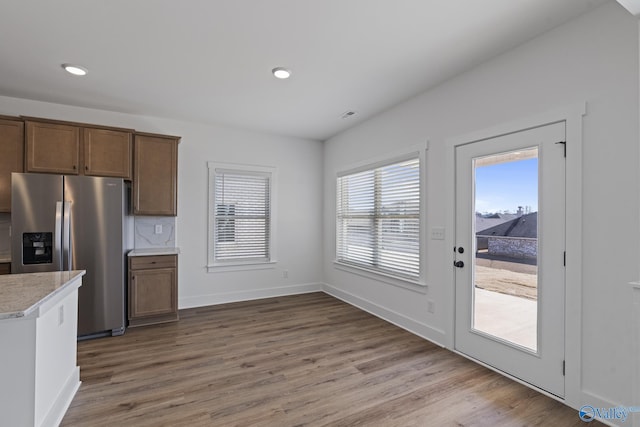 193 Chesire Cove Ln, New Market, AL 35761 - kitchen featuring wood finished floors, baseboards, recessed lighting, light countertops, and stainless steel fridge