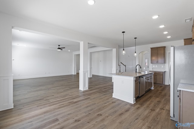 193 Chesire Cove Ln, New Market, AL 35761 - kitchen featuring wood finished floors, arched walkways, a sink, appliances with stainless steel finishes, and open floor plan