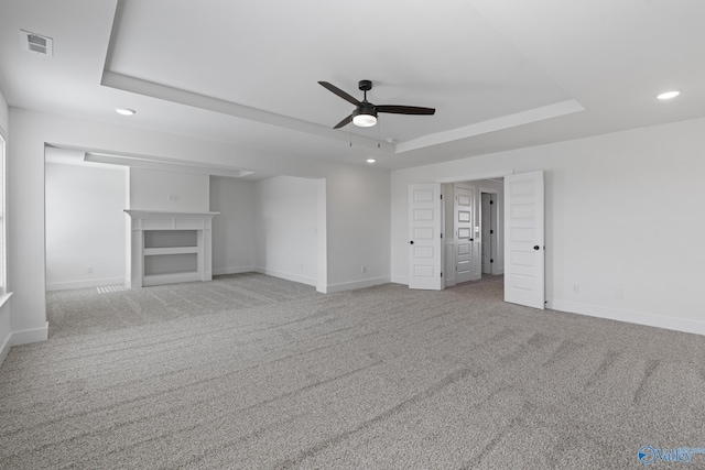 193 Chesire Cove Ln, New Market, AL 35761 - unfurnished living room with carpet flooring, a fireplace, a raised ceiling, and baseboards
