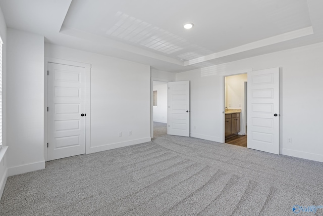193 Chesire Cove Ln, New Market, AL 35761 - unfurnished bedroom featuring a tray ceiling, carpet, and baseboards