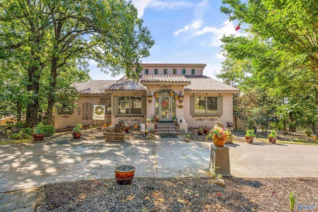 mediterranean / spanish home with a patio