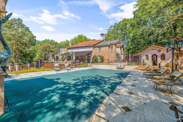 view of swimming pool featuring a patio area