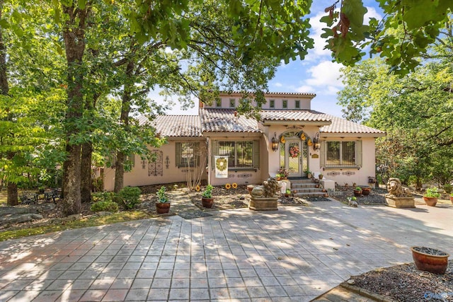 mediterranean / spanish home with a patio area