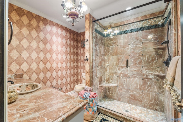 bathroom with vanity, crown molding, toilet, and a shower with door