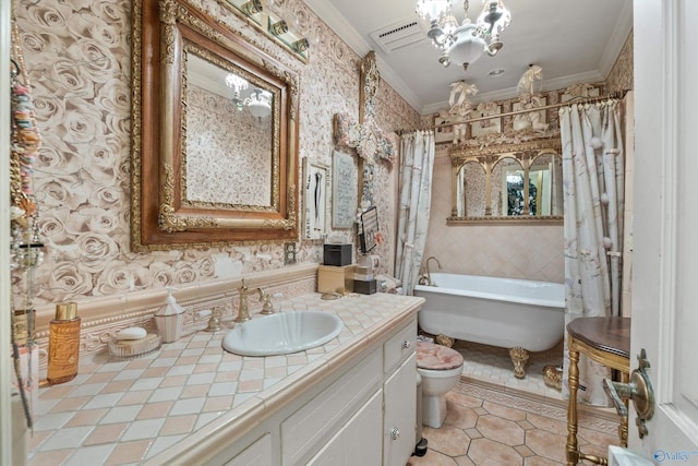 full bathroom featuring a notable chandelier, crown molding, vanity, and toilet