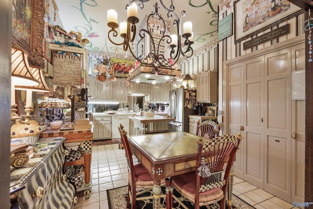 dining area featuring light tile patterned flooring and a chandelier