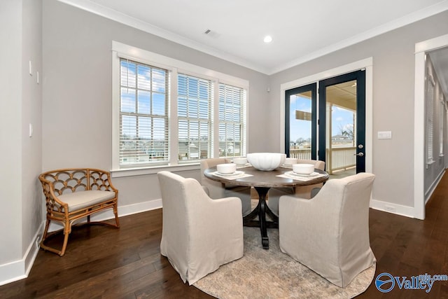 dining area featuring ornamental molding and dark hardwood / wood-style floors