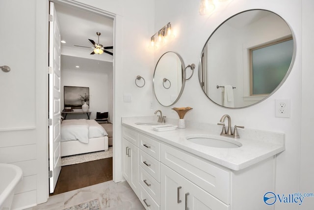 bathroom featuring ceiling fan and vanity