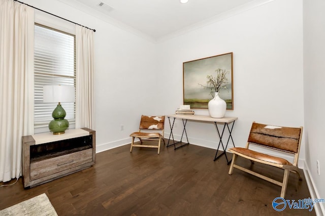 living area featuring ornamental molding and dark hardwood / wood-style floors