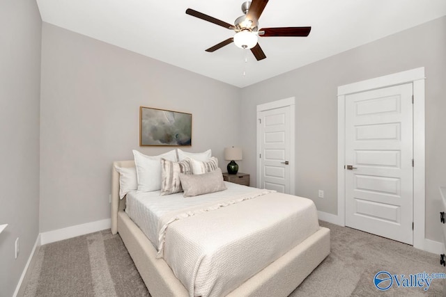 bedroom featuring ceiling fan and light carpet