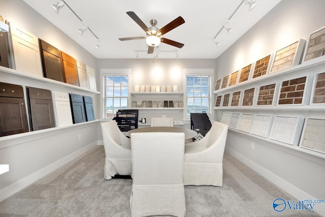 sitting room featuring light colored carpet, track lighting, and ceiling fan