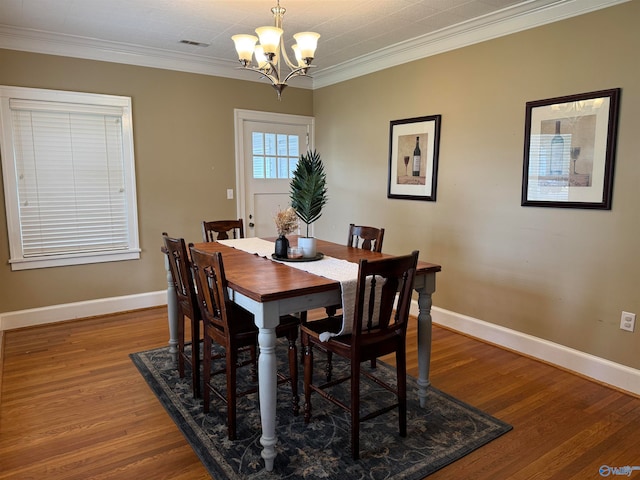 dining room with a notable chandelier, wood-type flooring, and ornamental molding