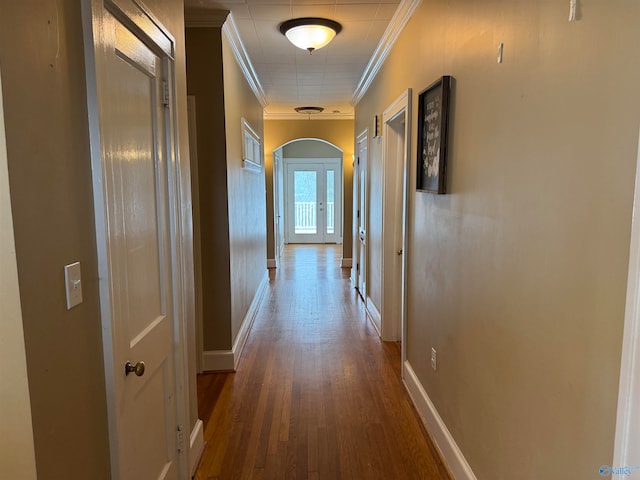 hallway with dark hardwood / wood-style floors and crown molding