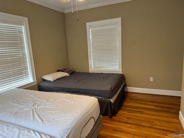 bedroom featuring hardwood / wood-style flooring and crown molding