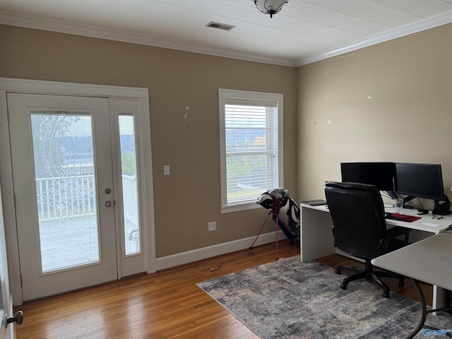 office space with light wood-type flooring and crown molding