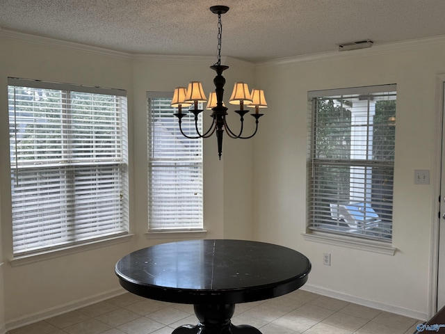 dining area with crown molding, a textured ceiling, a notable chandelier, and baseboards