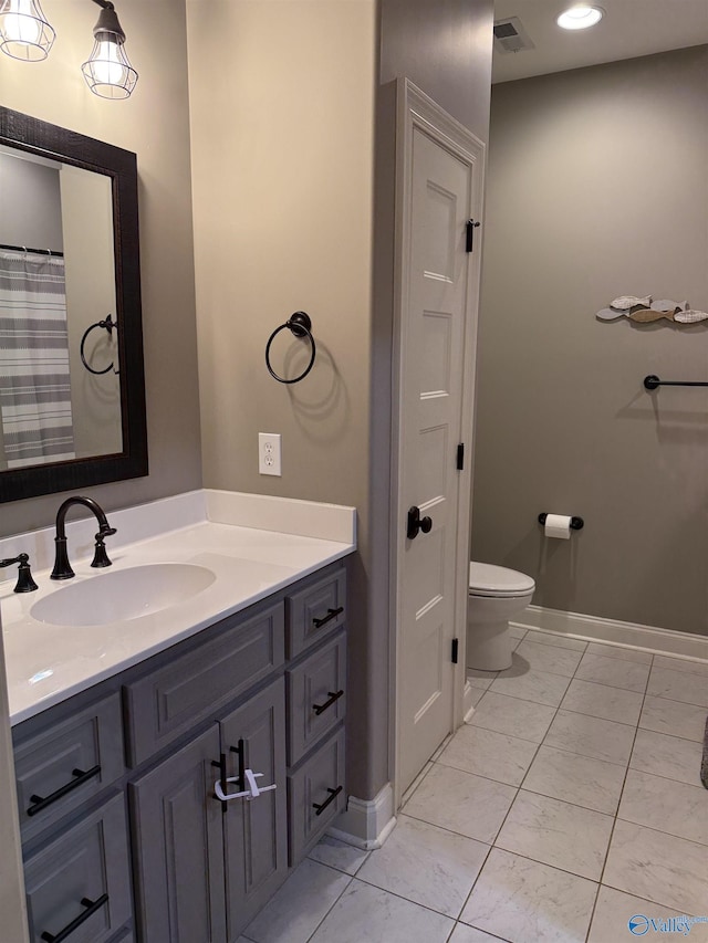 bathroom featuring vanity and toilet