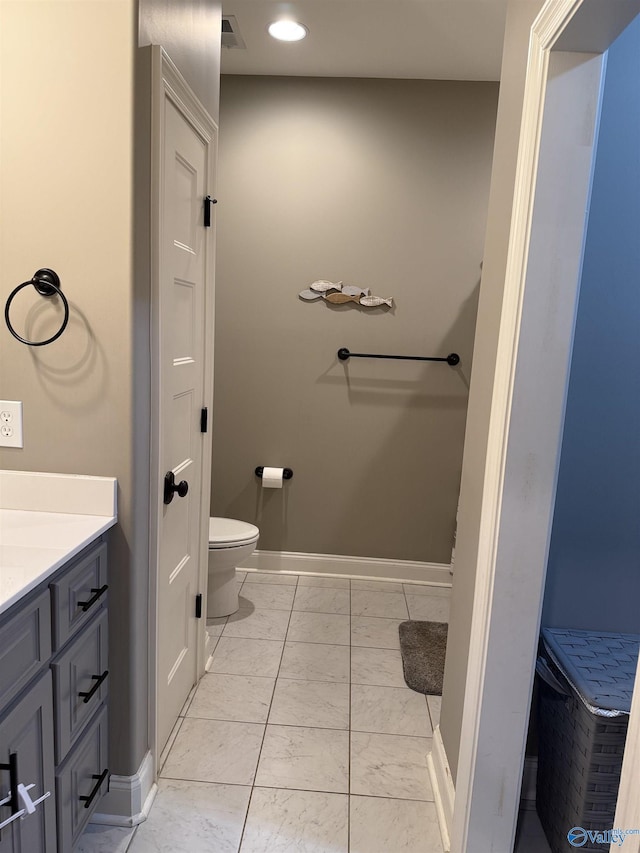 bathroom featuring vanity and toilet